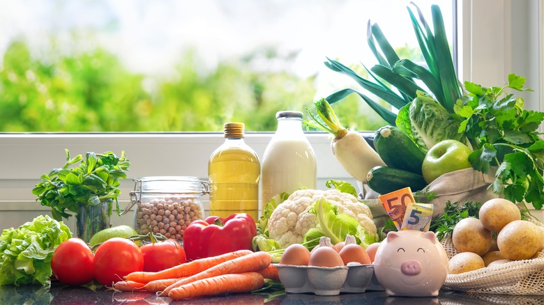 Groceries on counter with piggy bank