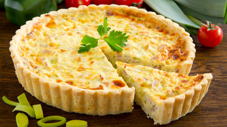 Whole quiche with cut slice 