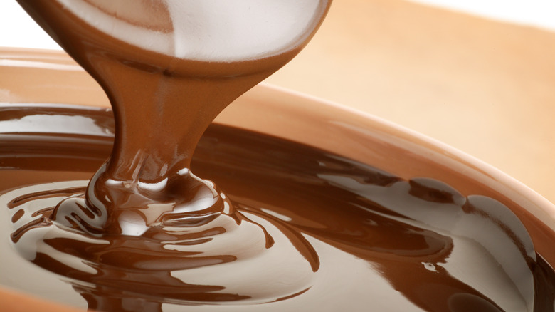 Someone pouring melted chocolate 