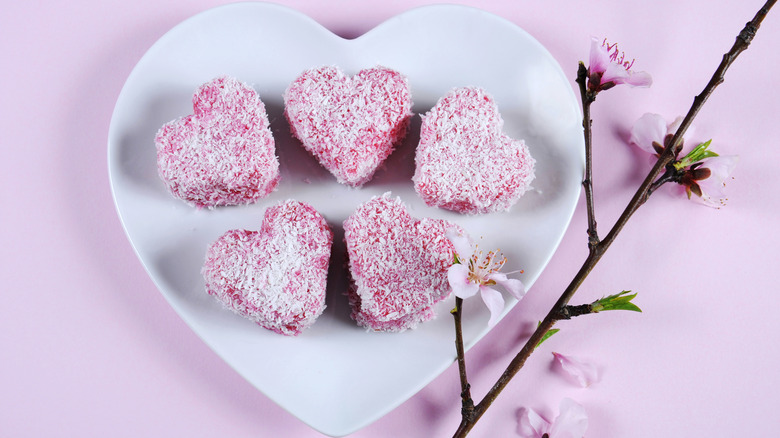 Australian lamingtons cut into hearts and covered in raspberry frosting