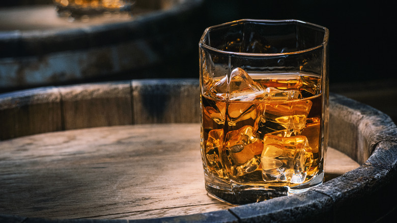 Whiskey glass on a barrel