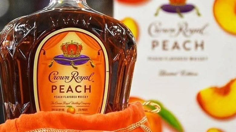 Bottle of Crown Royal Peach in orange bag with box in blurred background