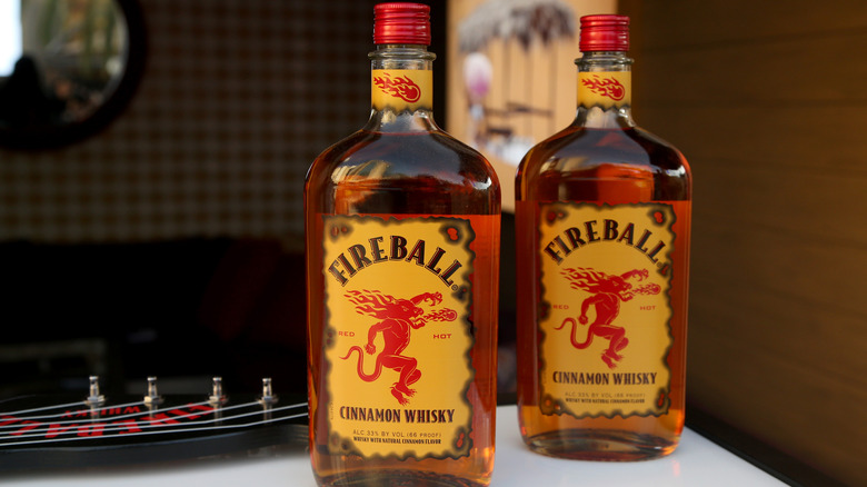 Two bottles of Fireball whiskey with blurred background