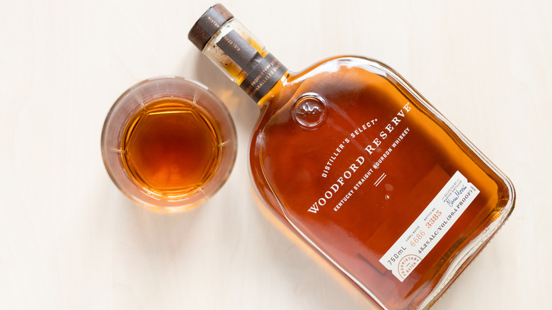 Bottle of Woodford Reserve on white background with glass
