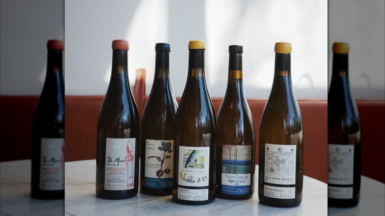 5 assorted wine bottles from Golden Age Wine on table