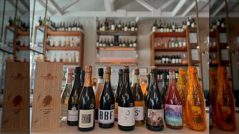 Assorted champagne bottles and wine racks on the background at Nouvelle Bar & Bottle