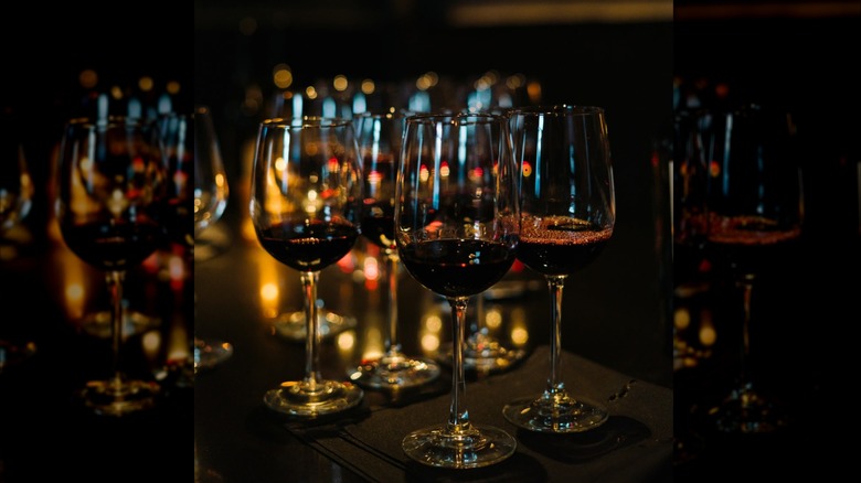 Several glasses of wine on a dim-lit table