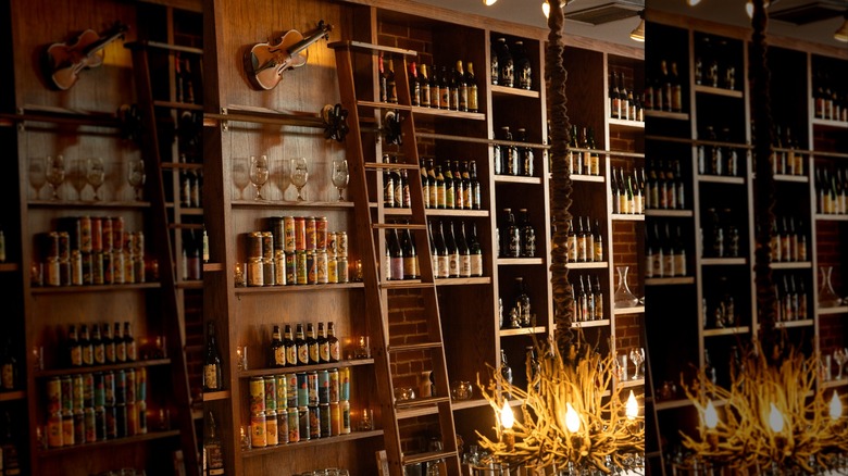 a wall with several shelves of beer and wine
