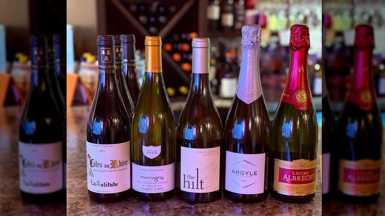 5 bottles of wine. From left to right: Cotes Du Rhone, Montagny, The Hilt, Argyle, and Lucien Albrecht