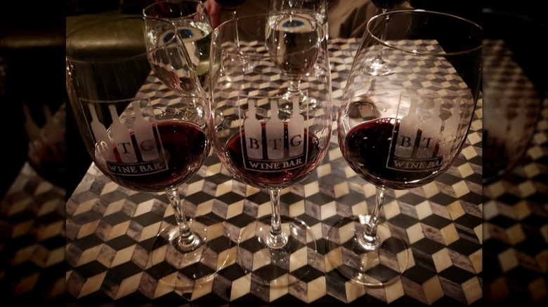 3 BTG Wine Bar wine glasses with the logo of the establishment.