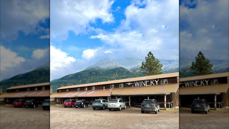 A long building that says Winery with mountains in the background
