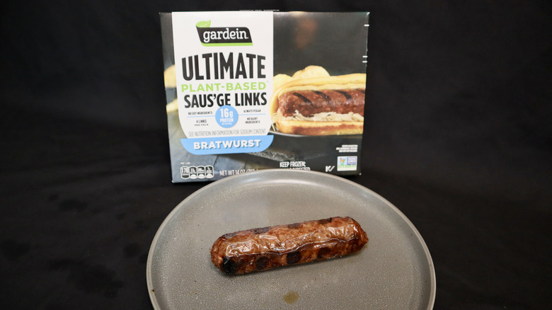 Gardein veggie brat on plate next to package