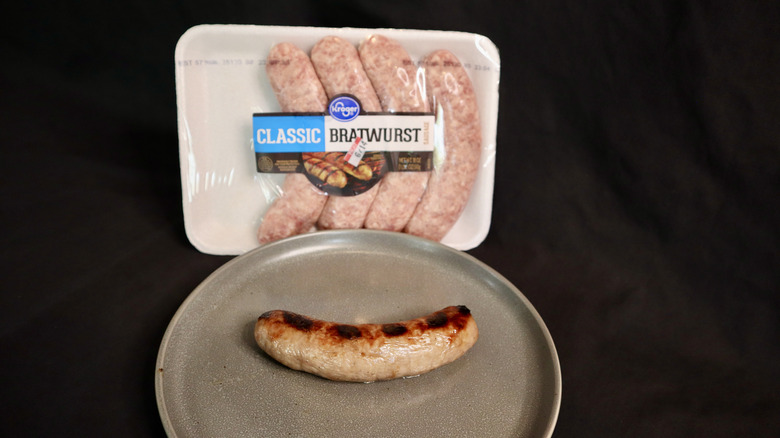 Kroger bratwurst on plate next to package