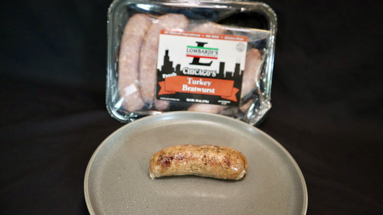Lombardi turkey brat on plate next to package