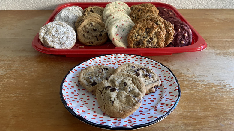 plated chocolate chunk cookies in front of cookie tray