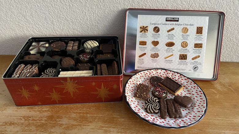 open European cookie tin beside plated selection of eight cookies