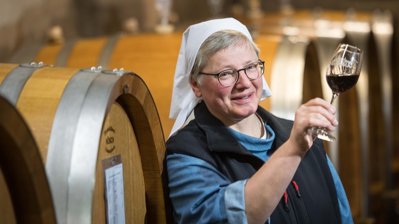 Nun holding glass of wine