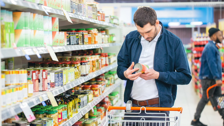 Man inspecting label at grocery store