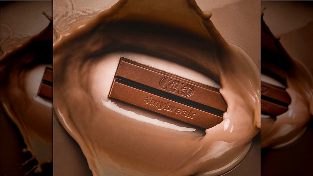 Kit Kat bars splashing into melted chocolate