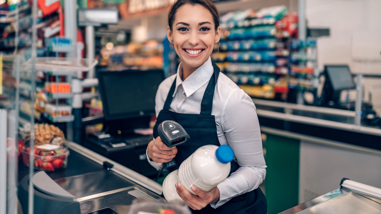 Woman smiling at grocery checkout