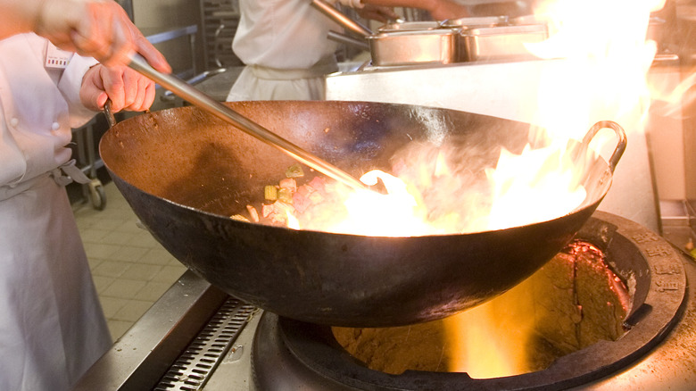 Chef over a fiery wok