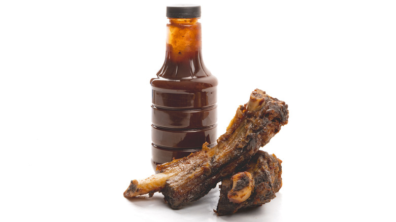 ribs with unlabeled BBQ sauce bottle