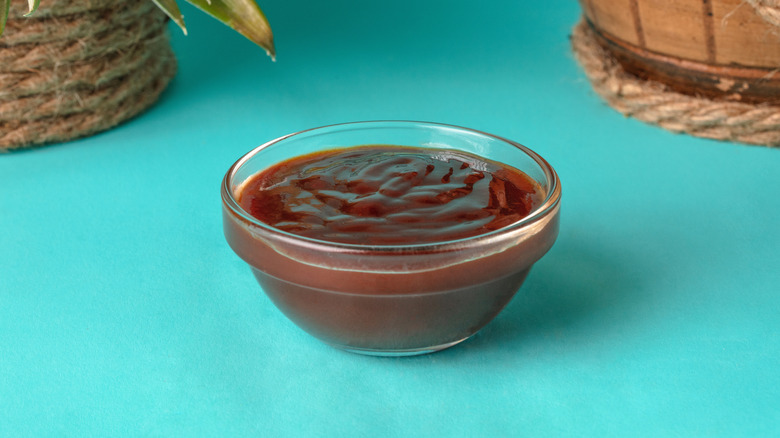 bbq sauce ramekin on blue background