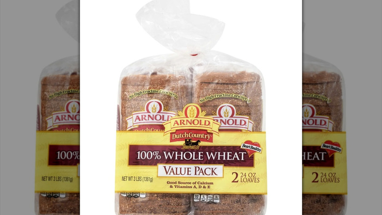 Two loaves of Arnold whole wheat bread on a white background