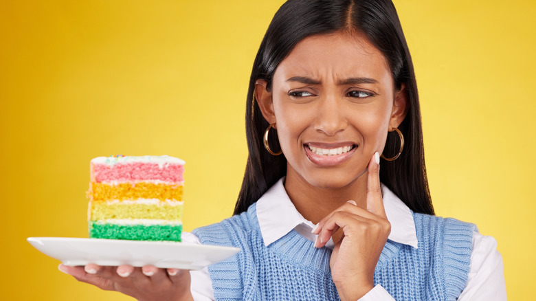 Person with cake looking dismayed
