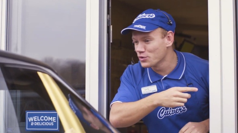 A worker at Culver's drive thru window