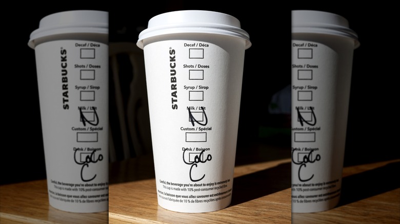 Starbucks paper takeout cup offers section to designate type of milk.