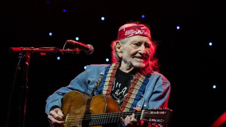 Willie Nelson playing guitar