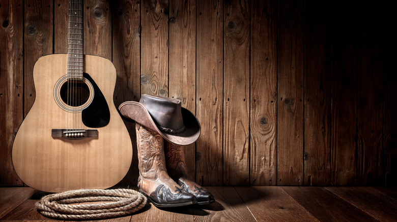 A guitar, cowboy boots, and a rope