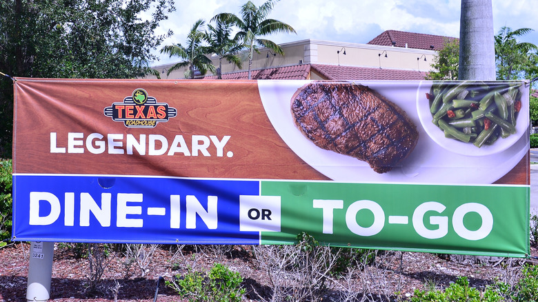 A sign advertising takeout at Texas Roadhouse