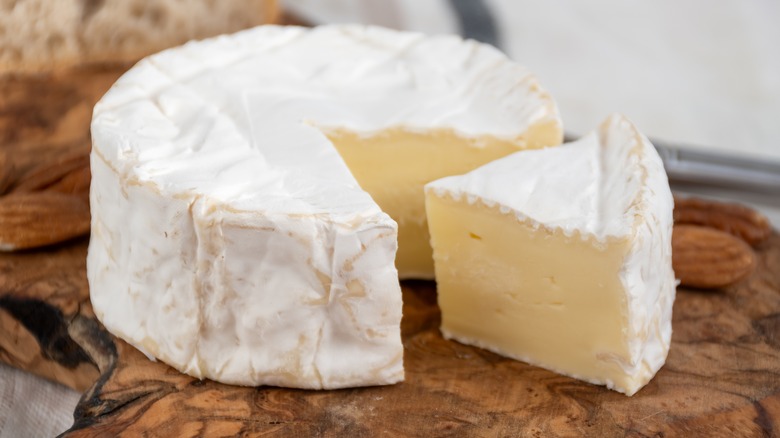 A wheel of Brie with a triangular slice removed