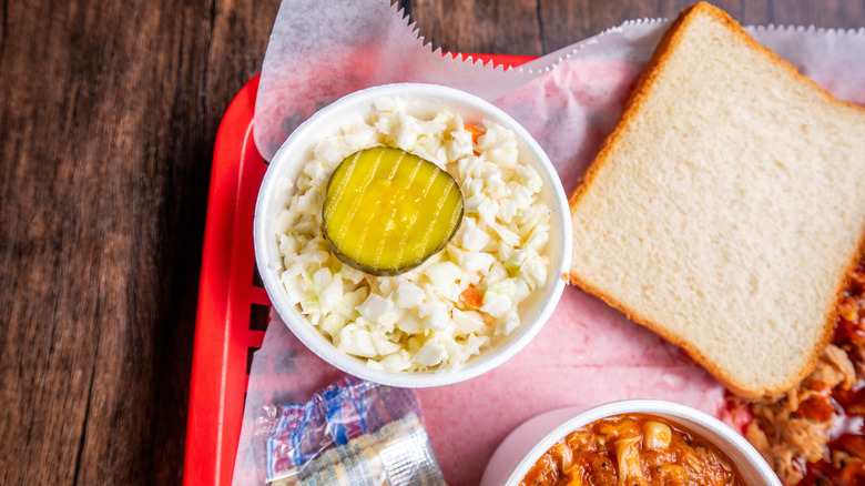 Food tray with cup of coleslaw, bread, and other items