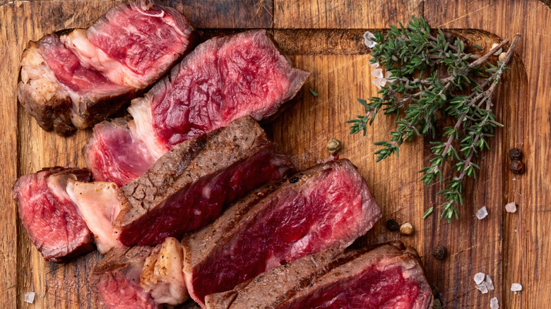 Sliced ribeye on wooden cutting board