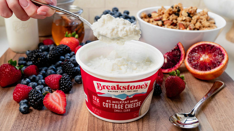 hand spooning Breakstone's 4% cottage cheese from a breakfast platter