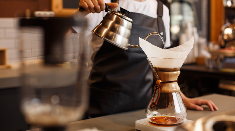 Barista pouring water in a Chemex
