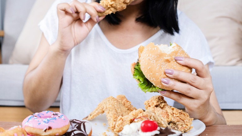 Person eating lots of fast food