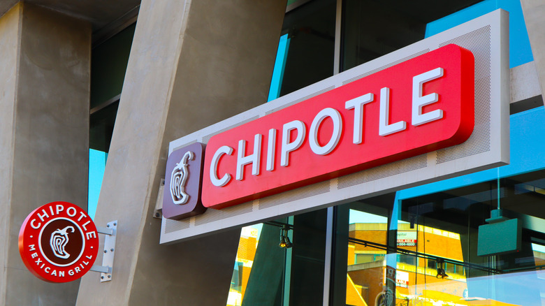 A red sign that reads Chipotle in white letters