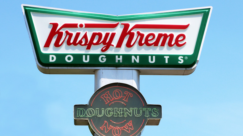 krispy kreme sign against a blue sky