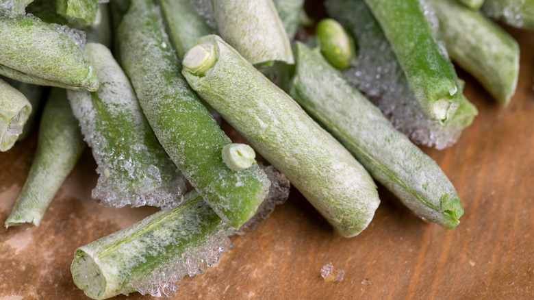 Frozen green beans on a cutting board