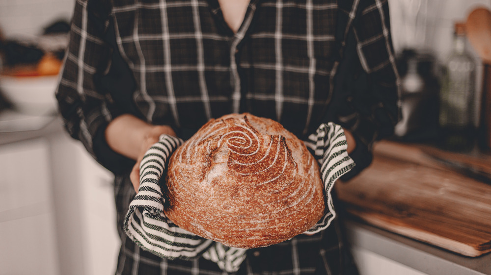 Person holding a boule of bread