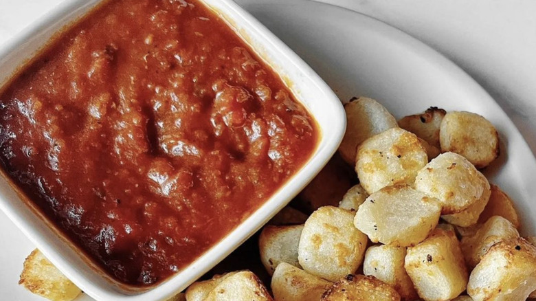 Ramekin of marinara sauce with cauliflower bites