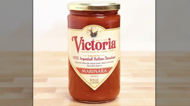 Jar of Victoria marinara sauce on wooden countertop