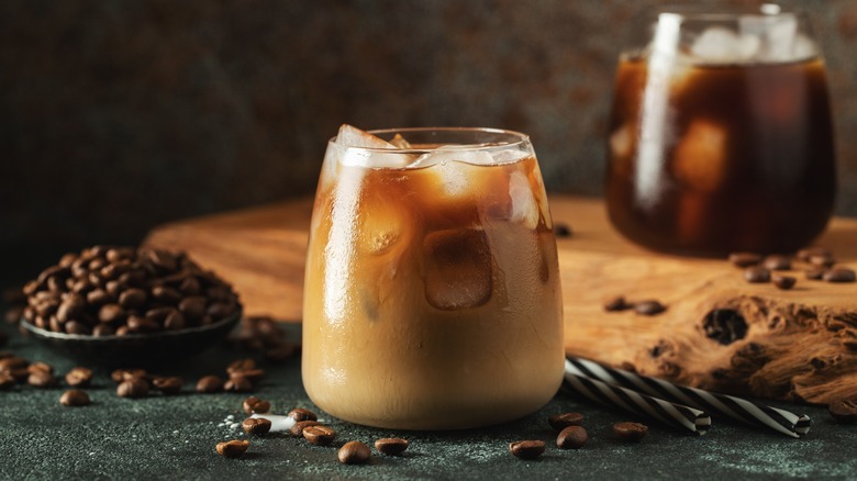 Iced coffee surrounded by beans