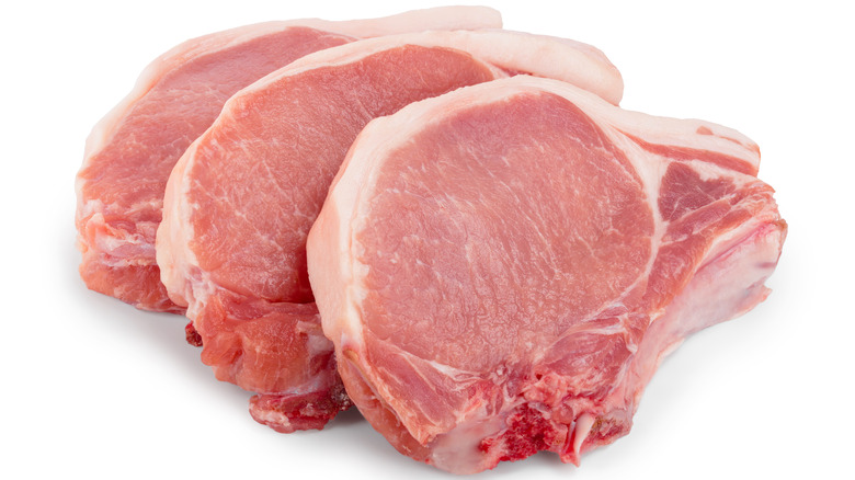 Fresh pork chops against a white background