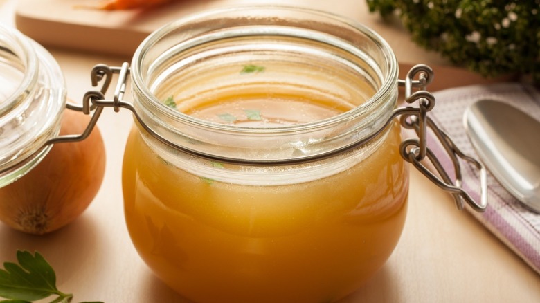 Chicken stock in a hinged glass jar.