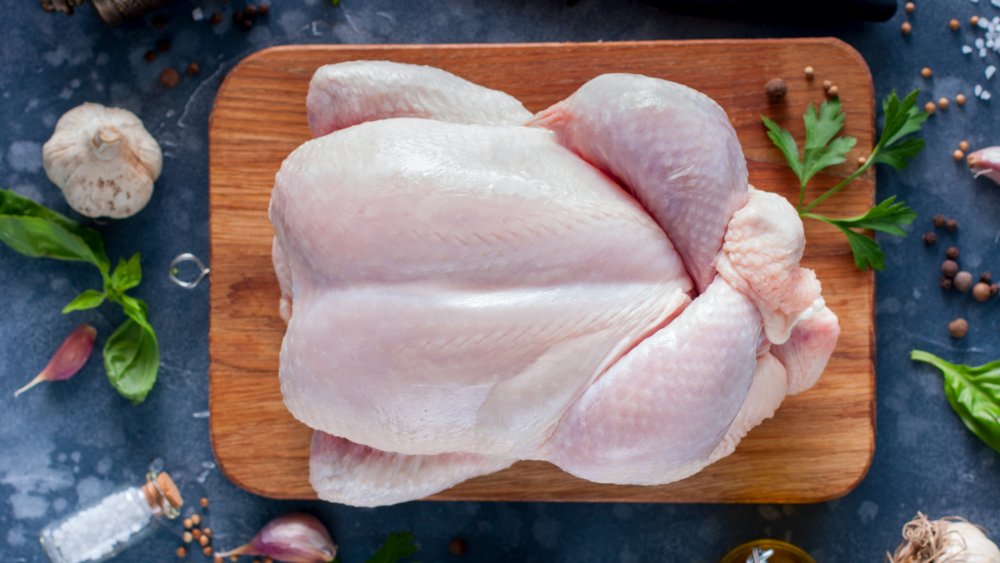 whole chicken on a cutting board